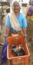 Beneficiary with chicks distributed to BPL families in Rama block