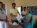 Dr Tomar from Krishi Vigyan Kendra, Jhabua awarding training certificates to murgi sakhi Surti Bai