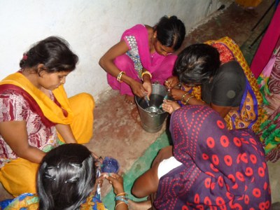 Trainee murgi sakhis practicing on filling syringes