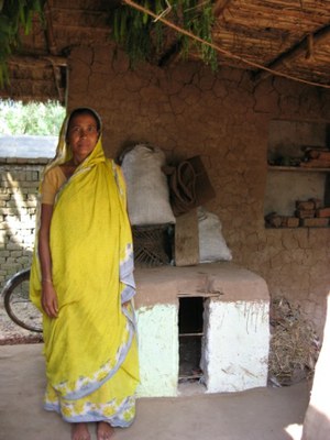 Murtaza Bibi in front of her poultry shed.
