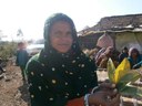 Ditubai Parmar from Sad village displaying the leaves of the custard apple tree