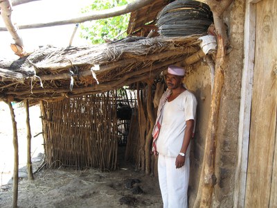 Rambhau Thakaji Pathvay standing infront of his goat shed 