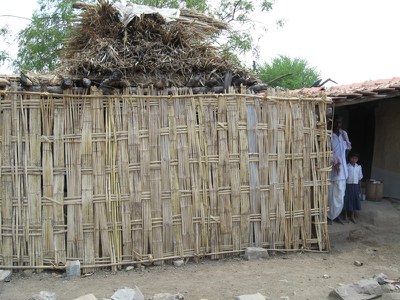 The side wall of the shed made of locally available bamboo sheets.